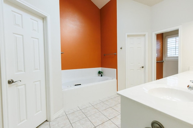 bathroom with vanity, tile patterned flooring, and tiled tub