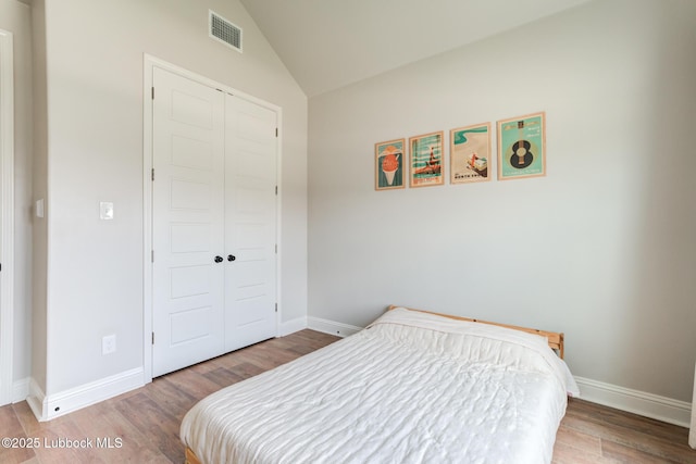 7008 17th St, Lubbock, TX 79416 - bedroom with a closet, vaulted ceiling, and wood finished floors