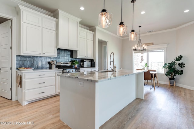 7008 17th St, Lubbock, TX 79416 - kitchen featuring stainless steel stove, light wood-style floors, decorative backsplash, white cabinetry, and recessed lighting