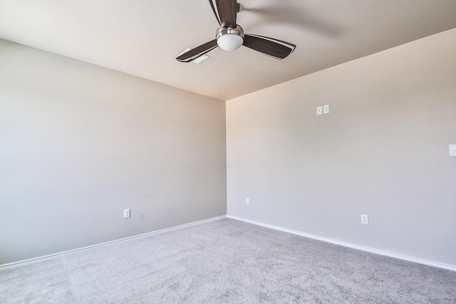 spare room with ceiling fan and carpet