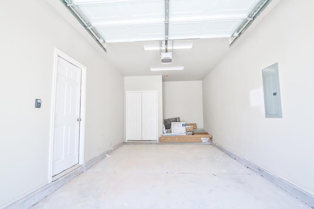 garage with a garage door opener and electric panel