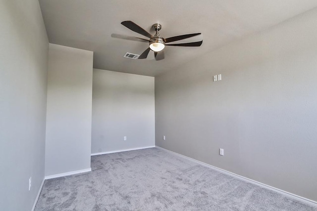 spare room featuring light colored carpet and ceiling fan