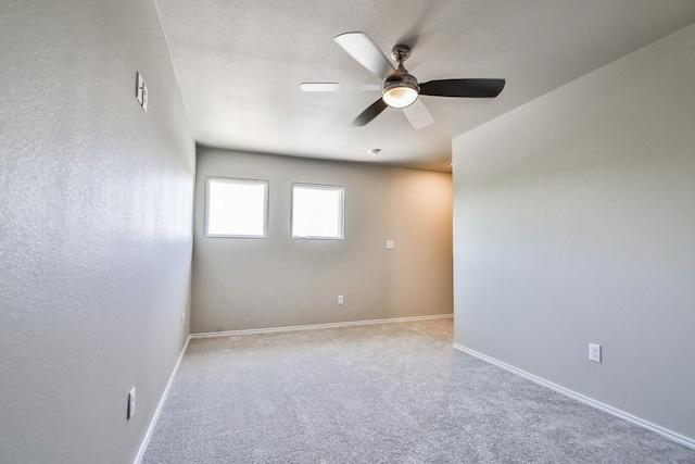 empty room featuring light colored carpet and ceiling fan