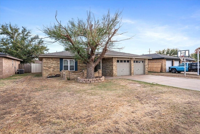 single story home featuring central AC, a garage, and a front yard