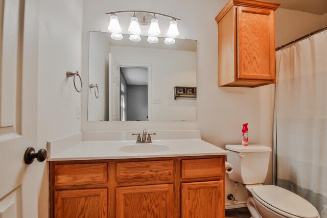 bathroom featuring vanity, a shower with shower curtain, and toilet