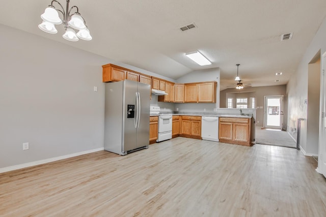 kitchen with decorative light fixtures, sink, kitchen peninsula, white appliances, and light hardwood / wood-style flooring