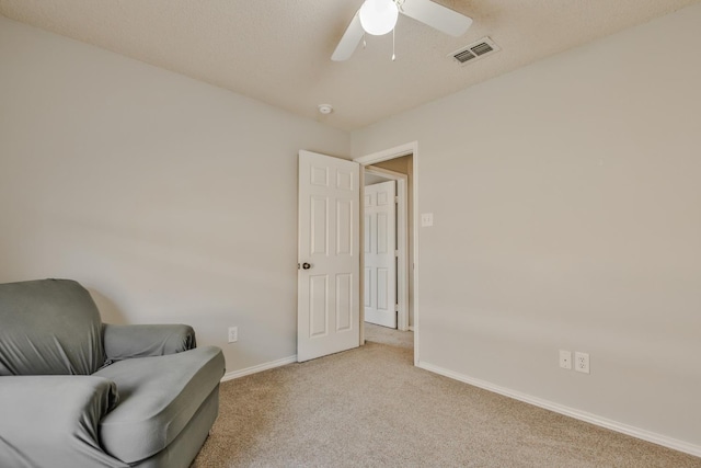 living area featuring ceiling fan and light colored carpet