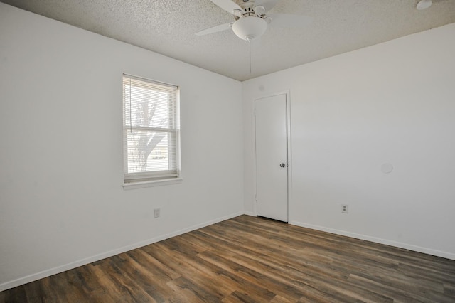 unfurnished room featuring ceiling fan, dark wood-type flooring, and a textured ceiling