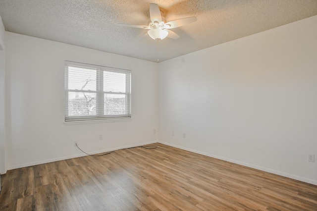 unfurnished room featuring ceiling fan, a textured ceiling, and light wood-type flooring