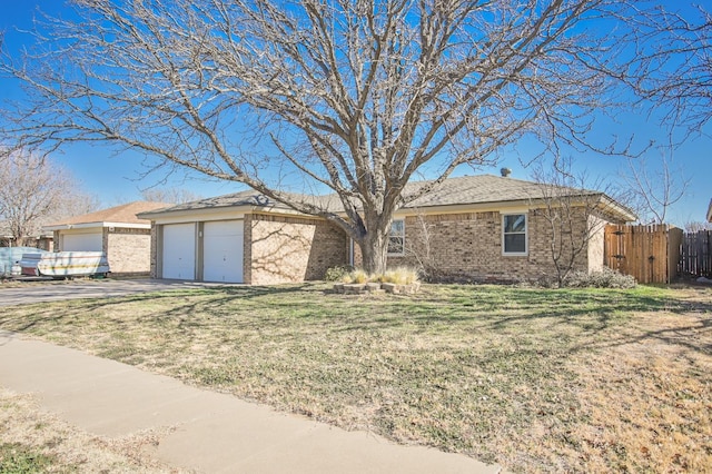 ranch-style house featuring a garage and a front yard