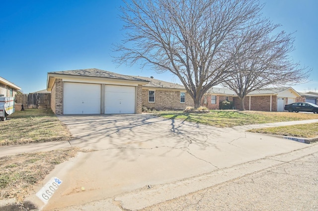 view of front of property with a garage and a front yard