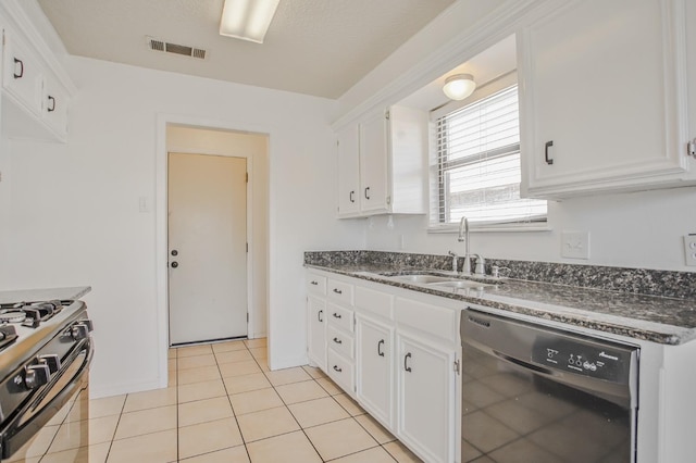 kitchen featuring sink, dishwasher, white cabinetry, light tile patterned flooring, and gas range