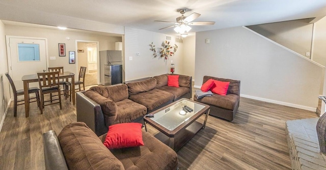 living room featuring ceiling fan and hardwood / wood-style floors