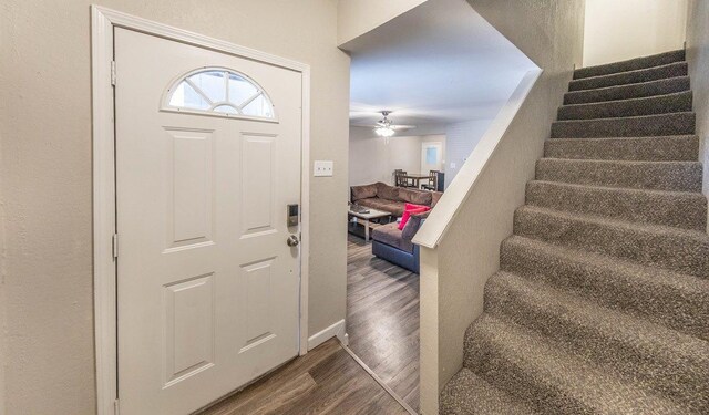 entryway with dark wood-type flooring and ceiling fan