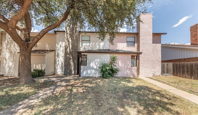 rear view of house with a yard