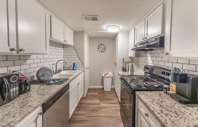 kitchen with sink, black appliances, dark hardwood / wood-style floors, and white cabinets