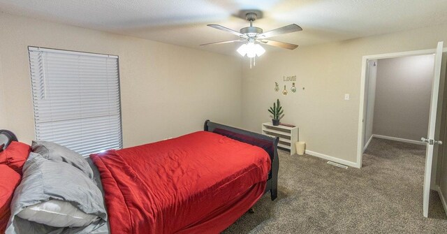 carpeted bedroom with ceiling fan and heating unit