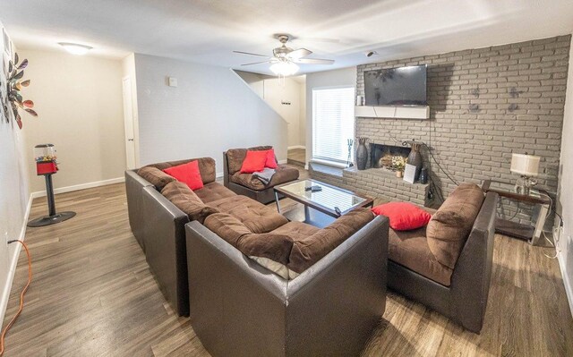 living room featuring hardwood / wood-style floors, a fireplace, and ceiling fan