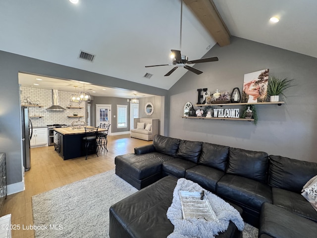 9906 Uvalde Ave, Lubbock, TX 79423 - living area with a chandelier, light wood finished floors, a ceiling fan, beam ceiling, and recessed lighting