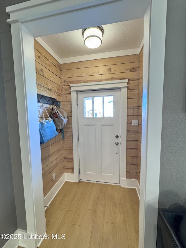 9906 Uvalde Ave, Lubbock, TX 79423 - foyer entrance with light wood-style floors and wood walls