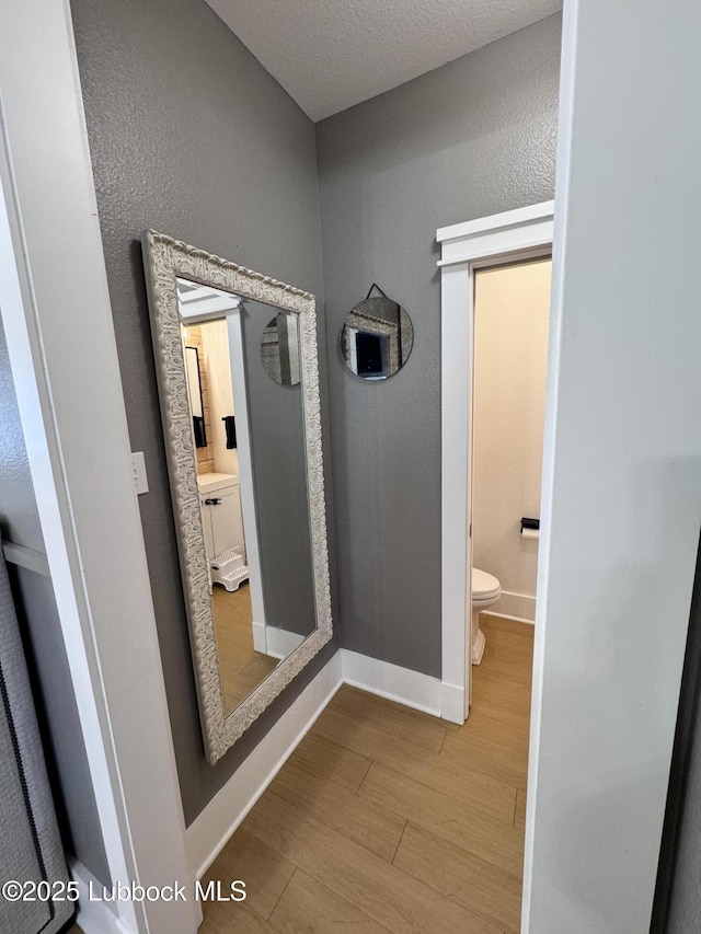9906 Uvalde Ave, Lubbock, TX 79423 - bathroom with wood finished floors and a textured ceiling
