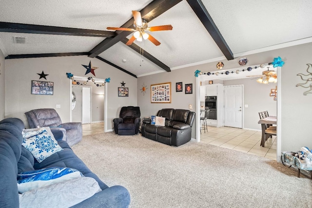 living room with vaulted ceiling with beams, light colored carpet, a textured ceiling, and ceiling fan