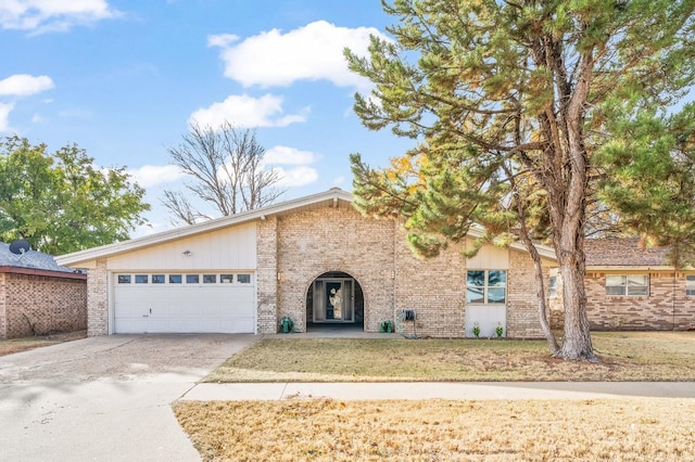 view of front of property featuring a garage and a front lawn