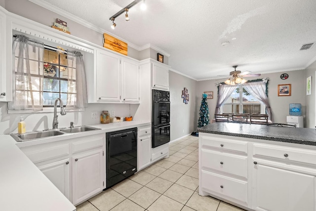 kitchen with white cabinetry, light tile patterned floors, sink, and black appliances