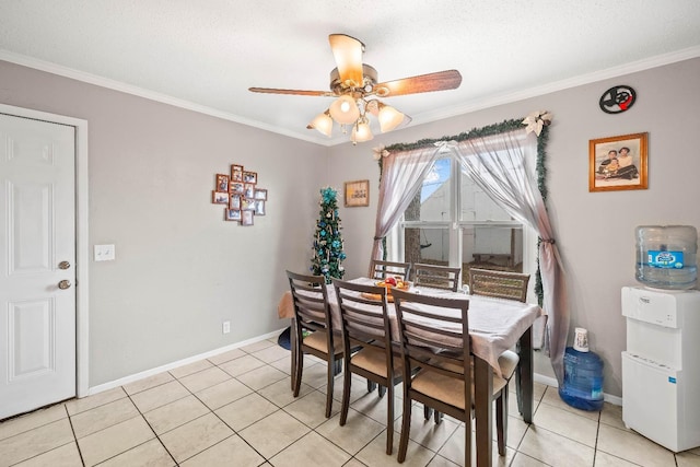 dining space featuring ornamental molding, light tile patterned flooring, and ceiling fan