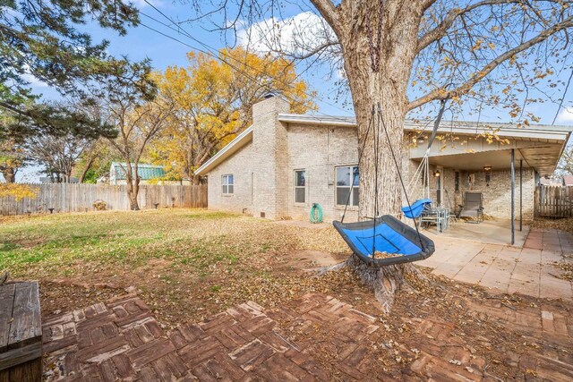 back of property featuring a yard and a patio