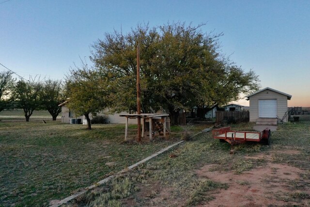 yard at dusk featuring a shed