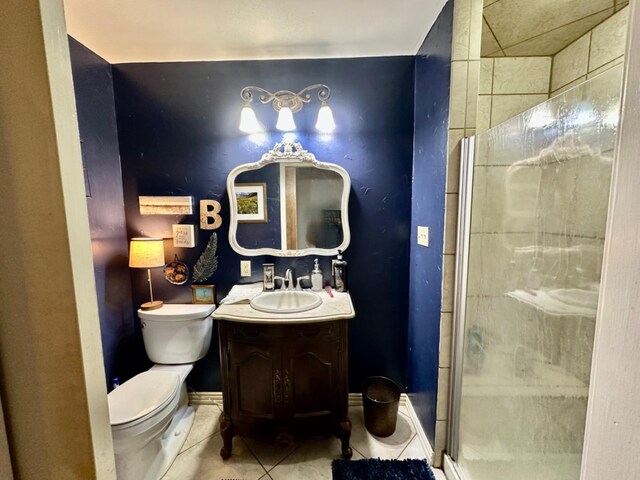 bathroom featuring tile patterned flooring, vanity, a shower with door, and toilet