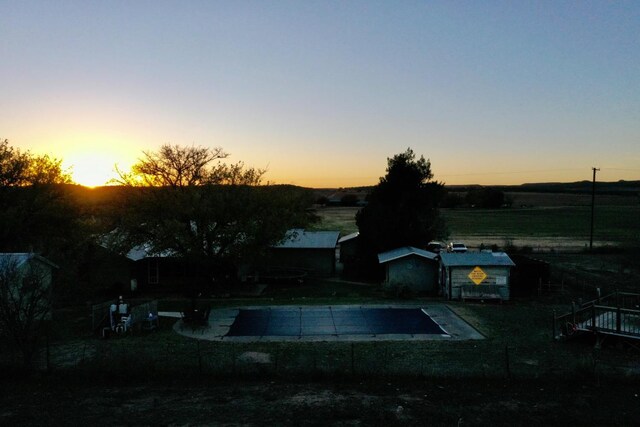 exterior space with a fenced in pool and a rural view