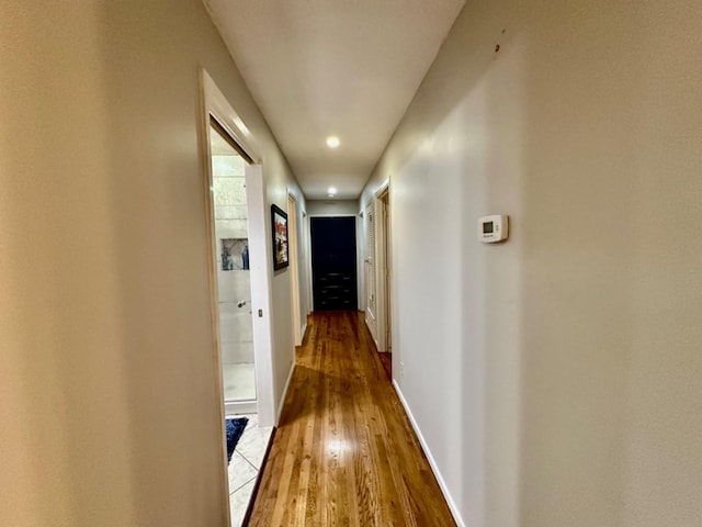 hall with wood-type flooring