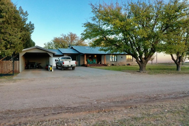 ranch-style home featuring a carport and a garage