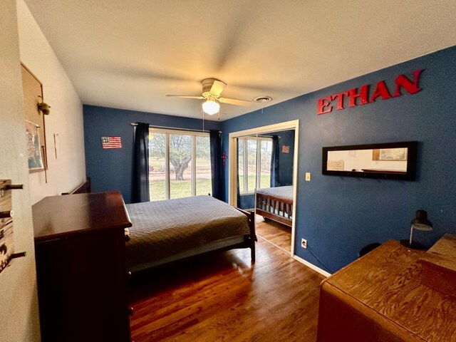 bedroom featuring ceiling fan, access to outside, and dark hardwood / wood-style flooring