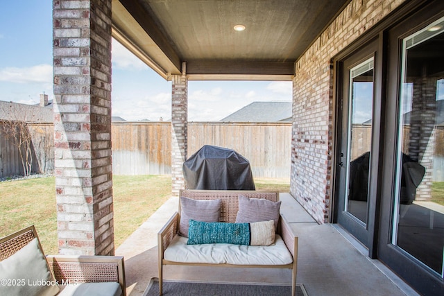 1308 Dover Ln, Wolfforth, TX 79382 - fenced backyard with area for grilling, outdoor lounge area, and a patio
