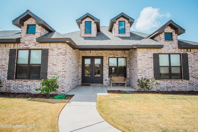 1308 Dover Ln, Wolfforth, TX 79382 - property entrance featuring a yard, brick siding, french doors, and a shingled roof