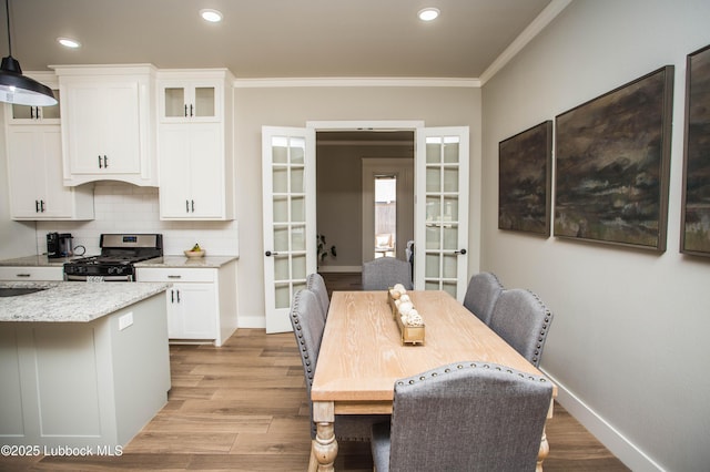 1308 Dover Ln, Wolfforth, TX 79382 - dining space with french doors, baseboards, ornamental molding, light wood-style floors, and recessed lighting