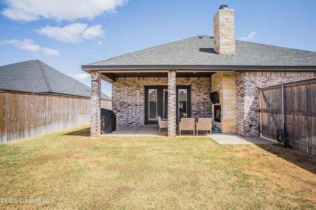 1308 Dover Ln, Wolfforth, TX 79382 - back of house with brick siding, roof with shingles, a patio, and a chimney