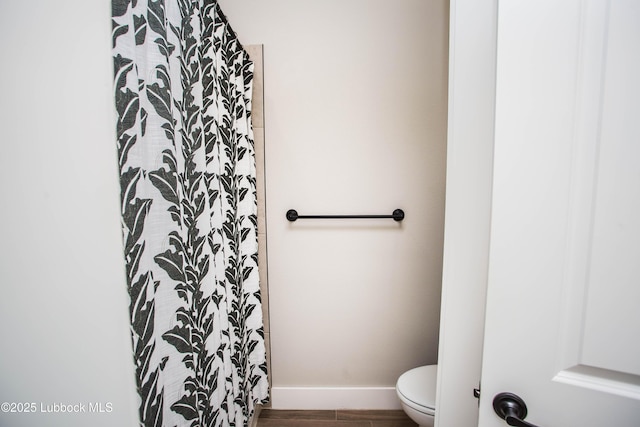 1308 Dover Ln, Wolfforth, TX 79382 - full bathroom with toilet, baseboards, a shower with curtain, and wood finished floors
