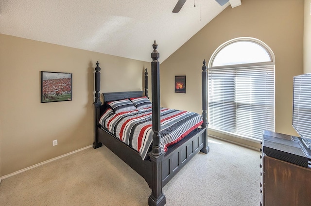 carpeted bedroom with ceiling fan, vaulted ceiling, and a textured ceiling