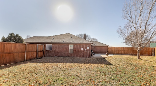 back of house with a patio and a yard