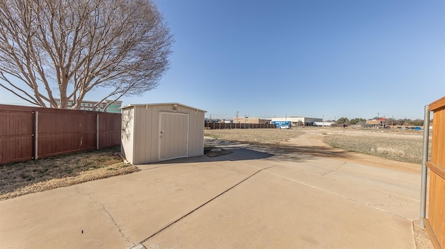 exterior space with a storage shed and a patio area