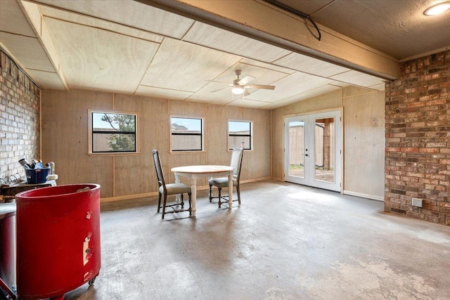 dining room featuring vaulted ceiling with beams, concrete floors, ceiling fan, and french doors