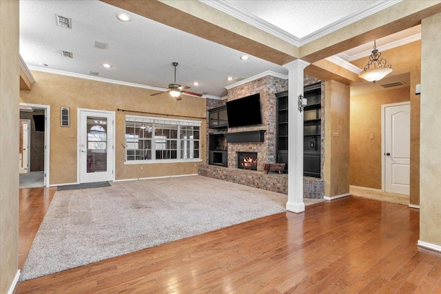 unfurnished living room featuring wood-type flooring, a fireplace, and a textured ceiling