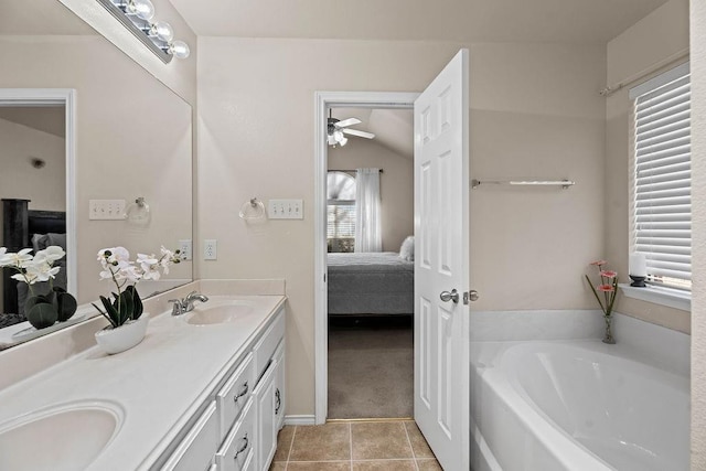 bathroom featuring vanity, a tub, and tile patterned floors