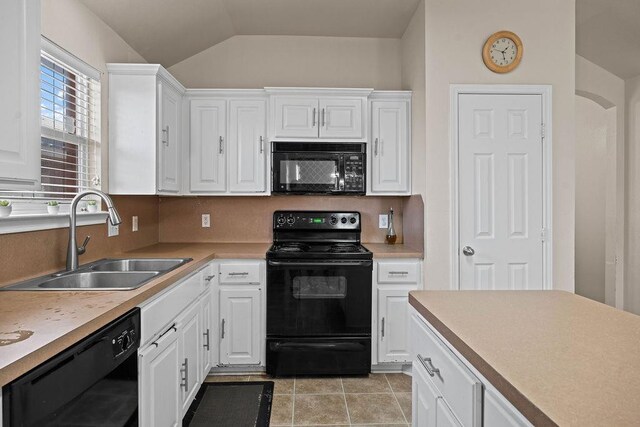 kitchen featuring light tile patterned flooring, white cabinetry, sink, decorative backsplash, and black appliances