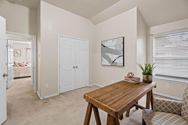 home office featuring vaulted ceiling and light colored carpet