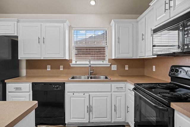 kitchen featuring white cabinetry, sink, and black appliances